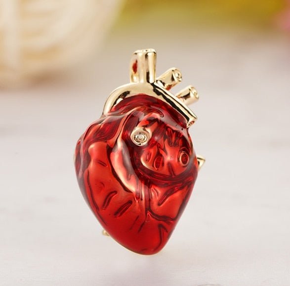 Anatomical heart lapel pin brooch in red and gold, featuring intricate detailing, perfect for adding a stylish and unique touch to any outfit.