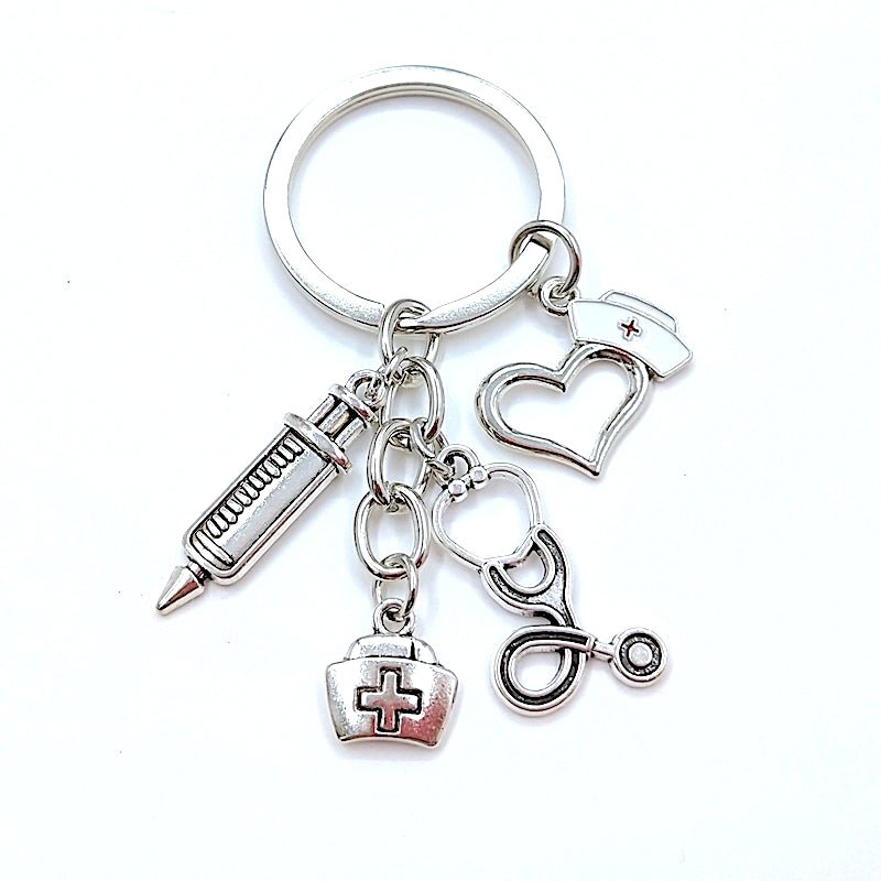 Nurse Hat and Charms Keyring in silver, featuring a charming nurse hat design along with decorative charms, perfect for celebrating the nursing profession and adding a touch of personality to your keys