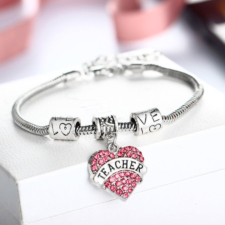 Teacher Pink Diamante Heart Bracelet - A stylish and elegant bracelet adorned with pink diamantes in a heart design, perfect for educators looking to add a touch of sparkle to their accessories.