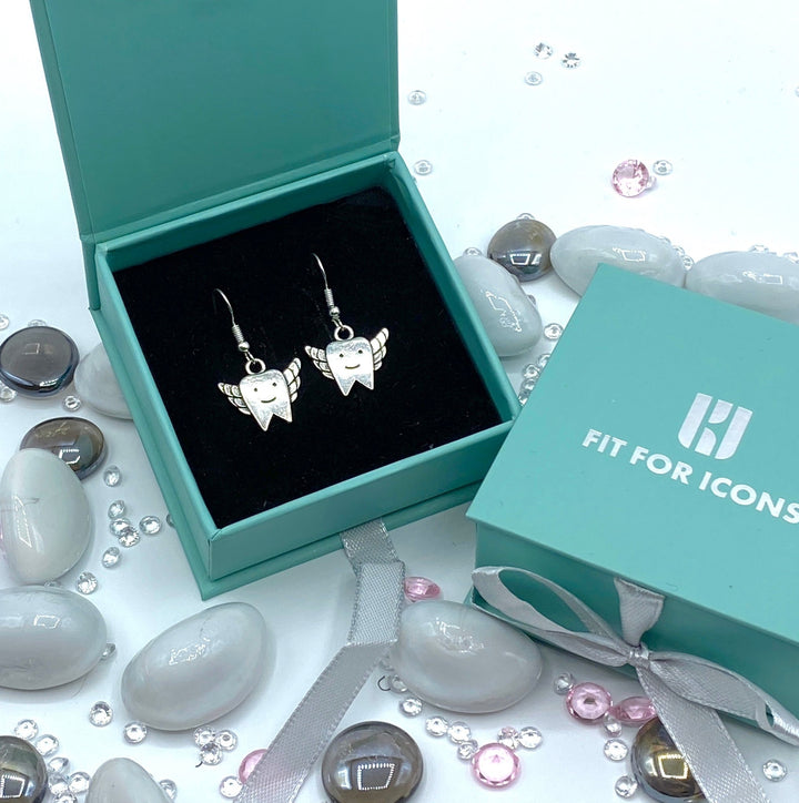 Elegant silver winged tooth fairy pendant earrings, perfect for celebrating dental milestones and adding charm to any outfit.