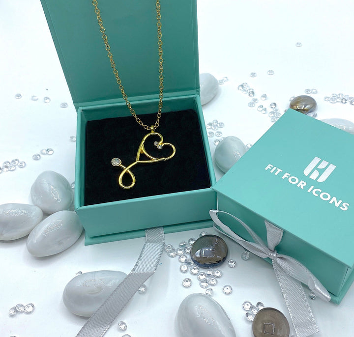 Gold stethoscope diamante pendant necklace, a chic accessory for healthcare professionals.