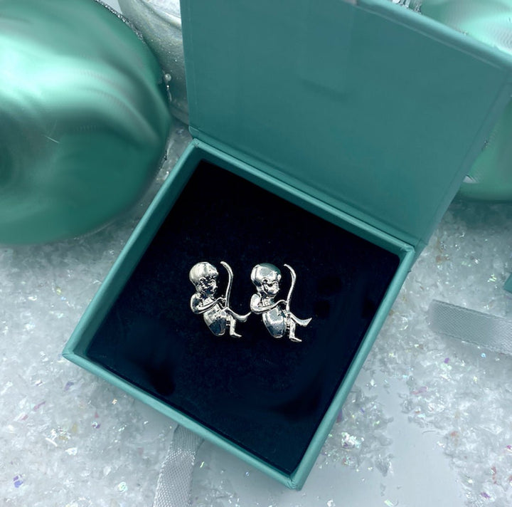 A pair of silver cufflinks shaped like a baby in the uterus, featuring a polished finish and intricate detailing, perfect for celebrating pregnancy.