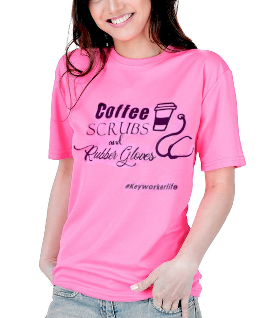 A pink t-shirt featuring the text "Coffee, Scrubs, and Rubber Gloves" along with a graphic of a coffee cup and medical scissors, highlighting the profession of healthcare workers. The shirt is set against a backdrop of greenery and flowers.