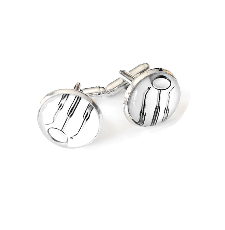 Elegant silver cabochon cufflinks designed with dental tools, perfect for dentists and dental professionals to showcase their passion for oral healthcare.