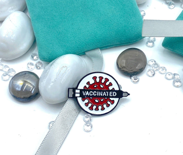 Red and White Vaccinated Lapel Pin, a vibrant accessory to advocate for vaccination and public health awareness.