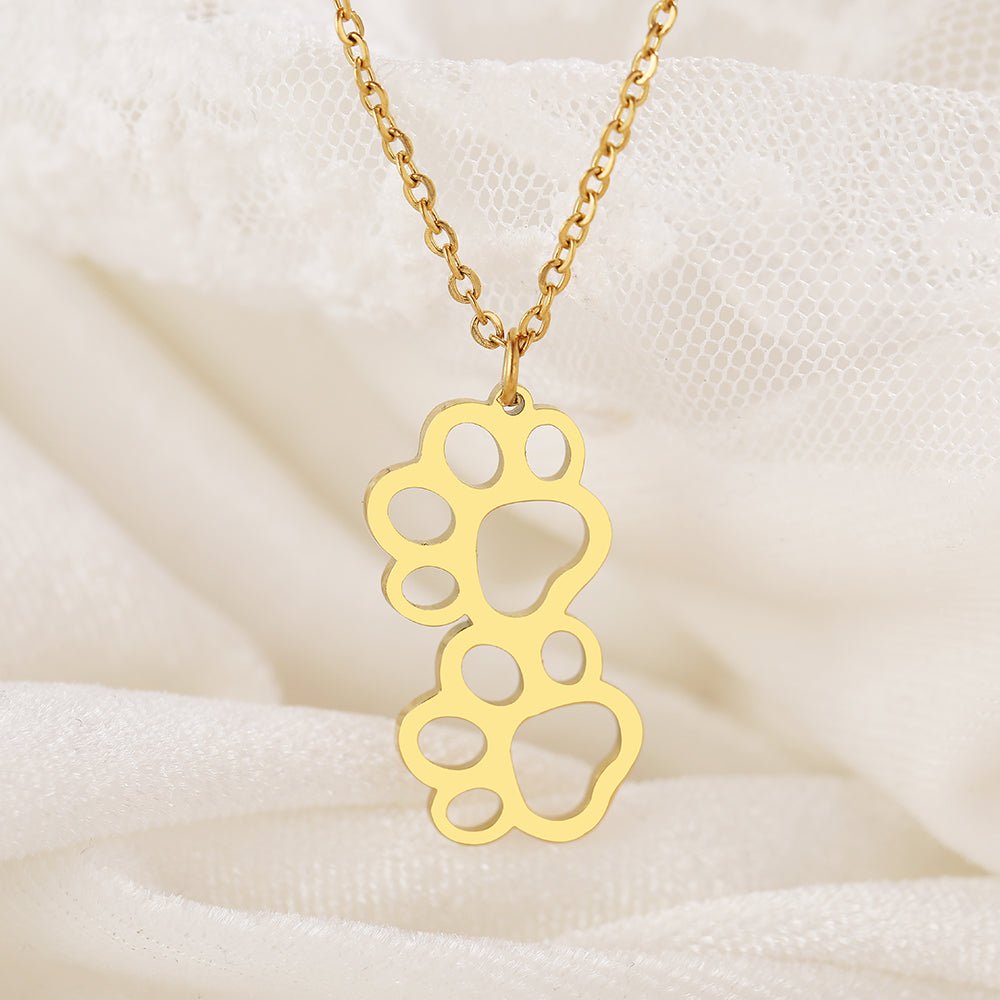 Charming double paw gold necklace, featuring delicate paw print designs, perfect for animal lovers and pet owners who want to showcase their affection for their furry friends.