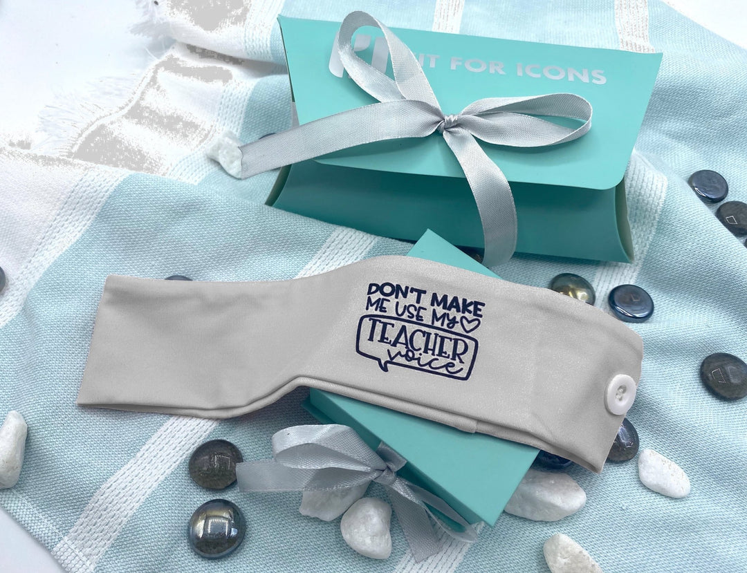 Grey headband with the phrase 'Don't Make Me Use My Teacher Voice,' perfect for educators looking to add a fun and playful touch to their style