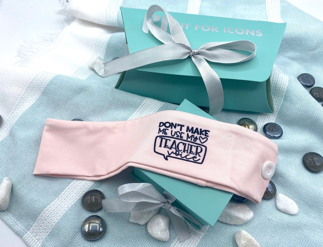 Teacher Education Headband in Pink - Featuring the humorous phrase 'Don't Make Me Use My Teacher Voice,' this playful headband is perfect for teachers looking to make a fun statement while staying stylish.