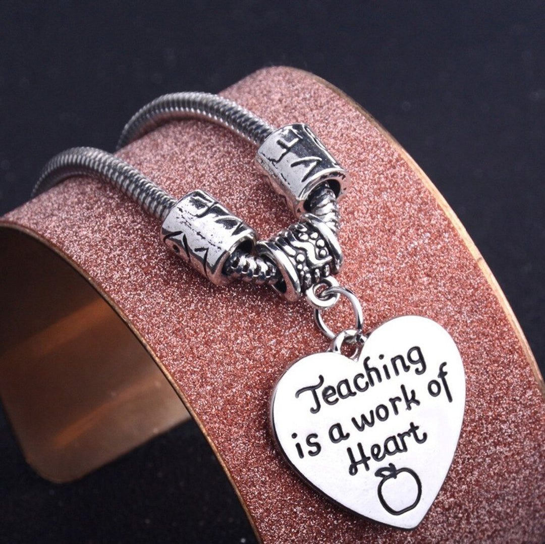 Teaching Is A Work Of Heart Bracelet - A beautifully designed bracelet featuring a heartfelt charm that embodies the dedication and passion of educators. This inspiring accessory makes a thoughtful gift for teachers, symbolizing their commitment to shaping young lives with love and care.