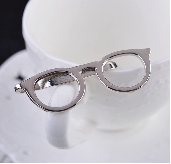 Silver optometrist spectacles tie pin featuring a sleek design, perfect for eye care professionals looking to add a stylish touch to their attire.