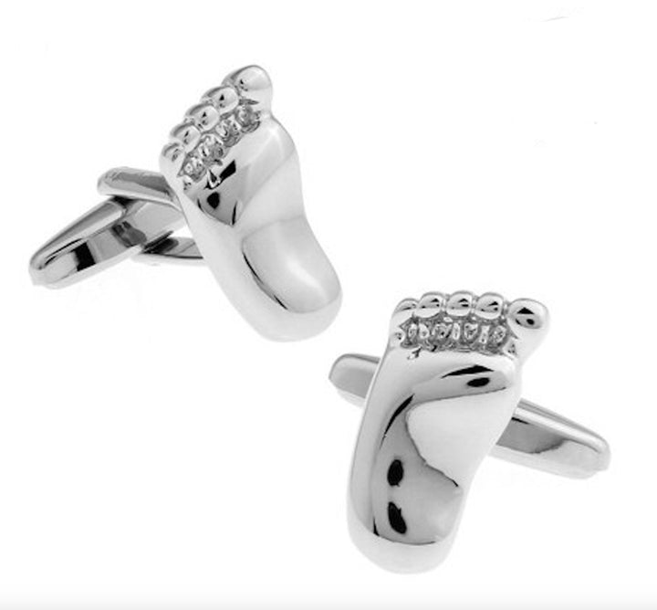 A pair of silver cufflinks shaped like baby feet, featuring intricate detailing and a polished finish, may appeal to pediatricians or child care professionals, as well as parents looking for unique accessories to celebrate their profession or parenthood.