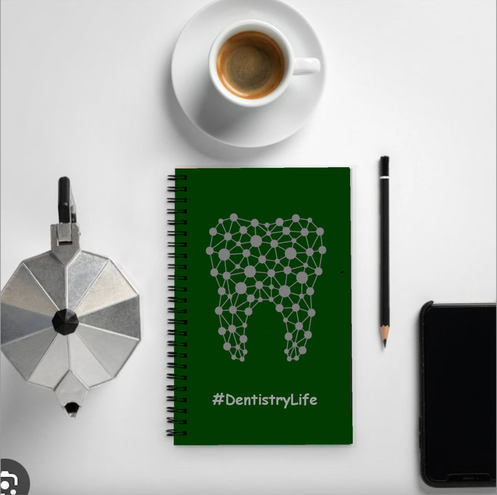 A stylish notebook featuring an abstract tooth design on the cover, ideal for dental professionals and students, placed on a flat surface.