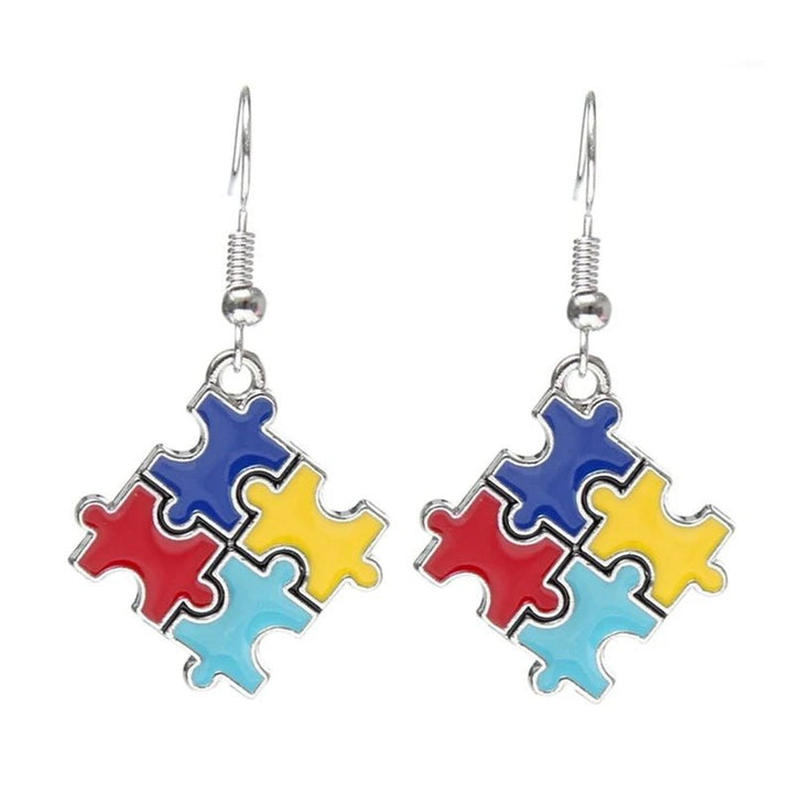 Colorful puzzle piece earrings in red, blue, yellow, and turquoise, symbolizing support for individuals with autism, perfect for healthcare and education professionals.