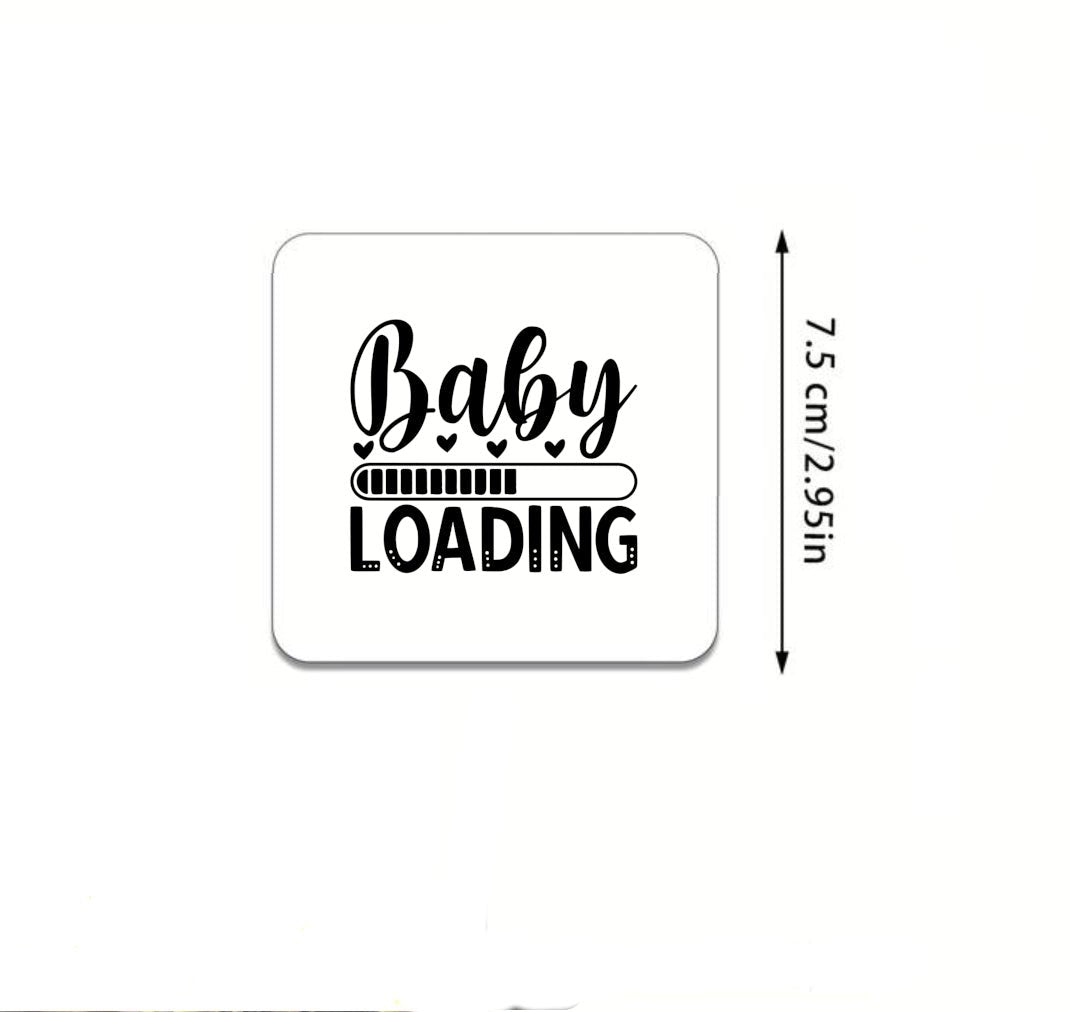 A fridge magnet featuring a playful "Baby Loading" design, showcasing baby footprints to celebrate pregnancy and impending parenthood.