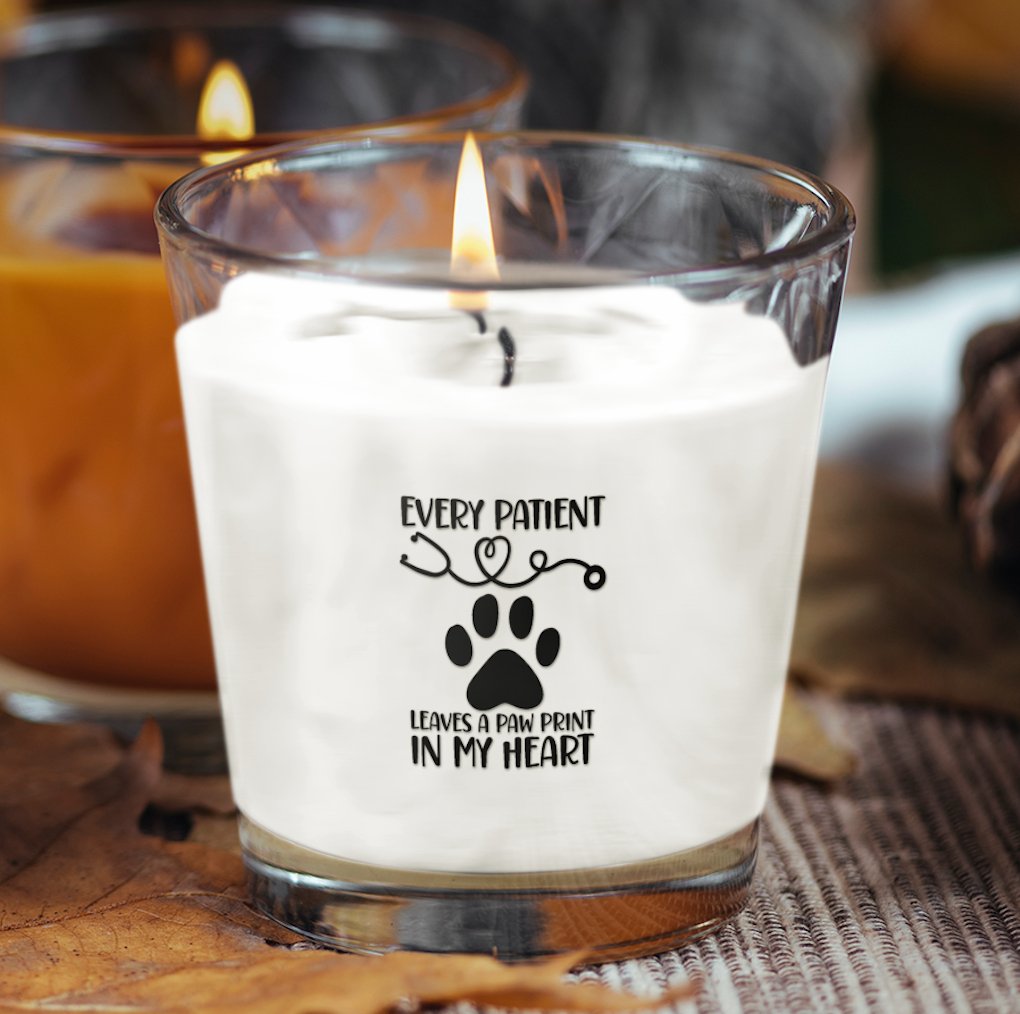 Scented candle featuring a charming pawprint patients design, perfect for animal lovers looking to create a relaxing atmosphere.