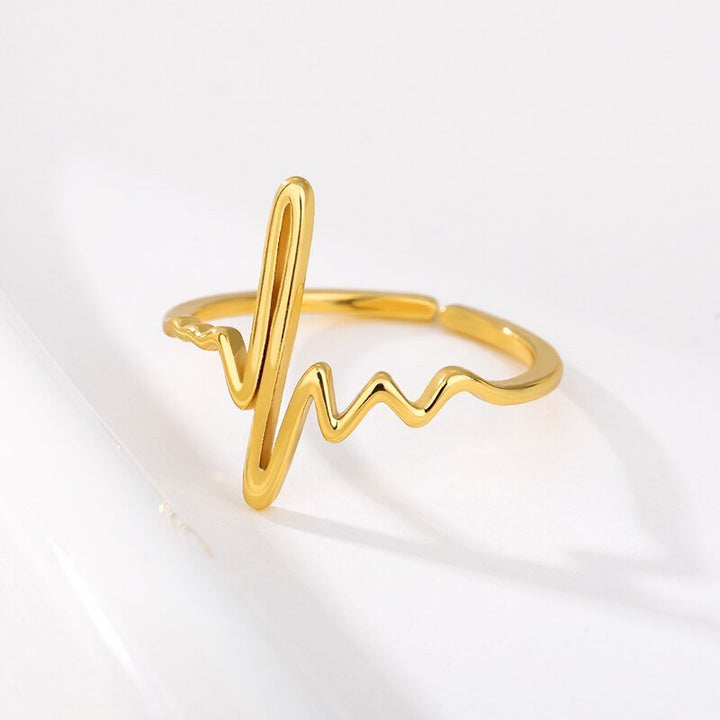 Heartbeat Ring in Gold, a stylish and meaningful accessory symbolizing life and care. Perfect for healthcare professionals and those in the medical field, this ring adds a touch of elegance to any outfit.