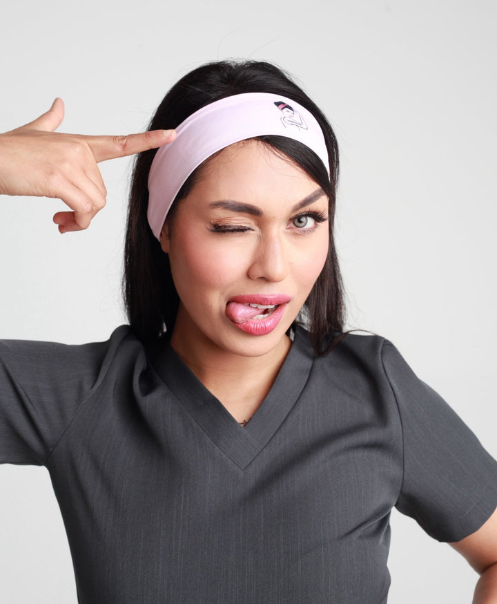 "Unbreakable Woman" logo headband in pink, designed for comfort and style, ideal for workouts or casual wear, symbolizing empowerment and resilience.