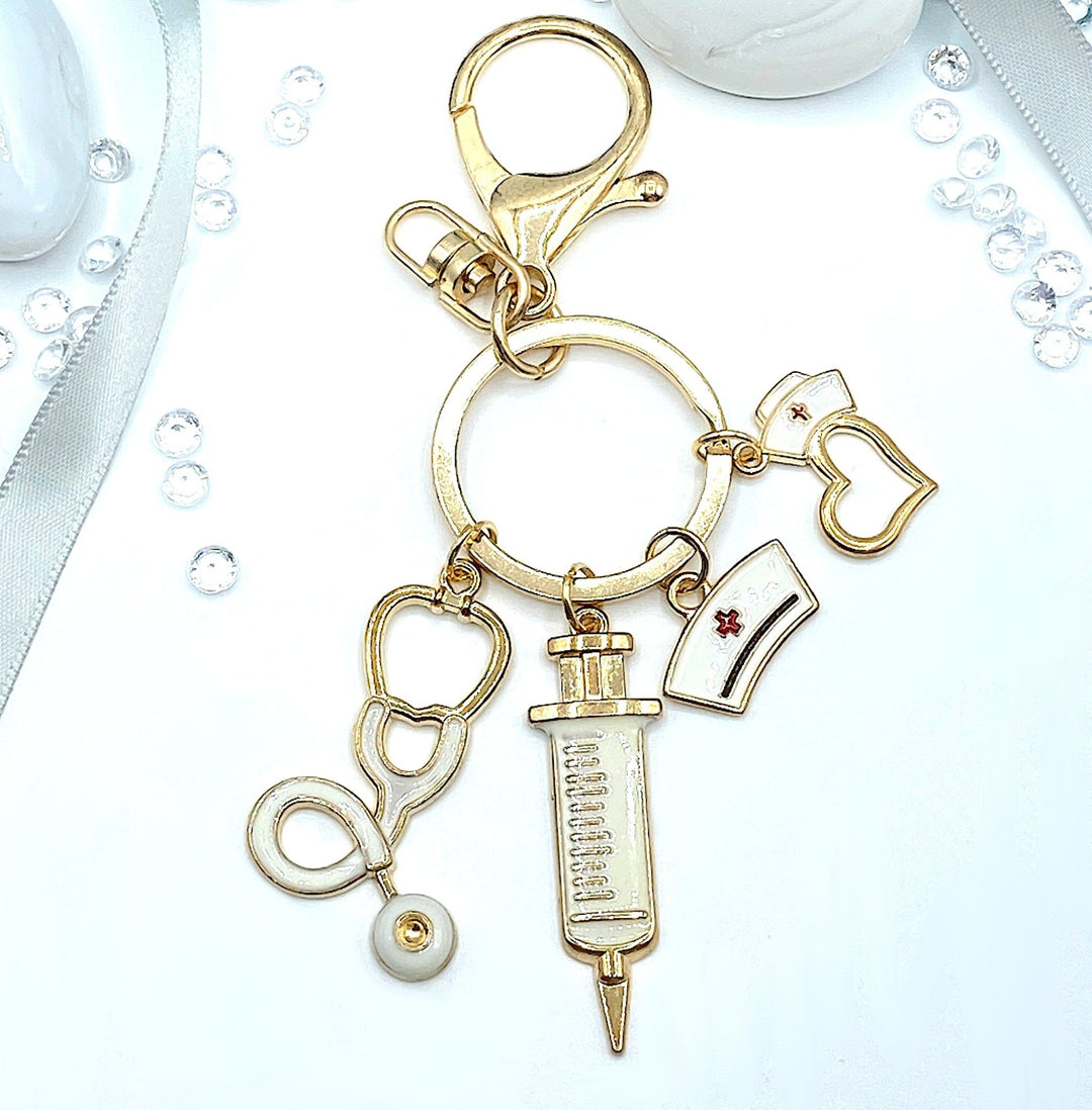 Nurse Hat and Charms Keyring in white and gold, featuring a stylish nurse hat design and decorative charms, perfect for honoring the nursing profession and adding a touch of elegance to your keychain.