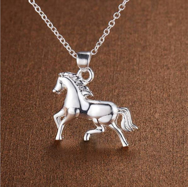 A silver necklace with a pendant in the shape of a galloping horse, representing the veterinary profession.