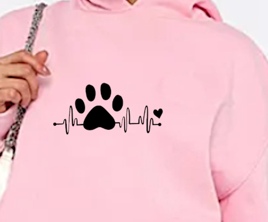 a close up of the slogan on the pink hoodie by keryworker gift site Gifts For Icons showing a large paw in the centre of the slogan and a heartbeat rhythm to either side and a small pink heart at the end of the heartbeat line.