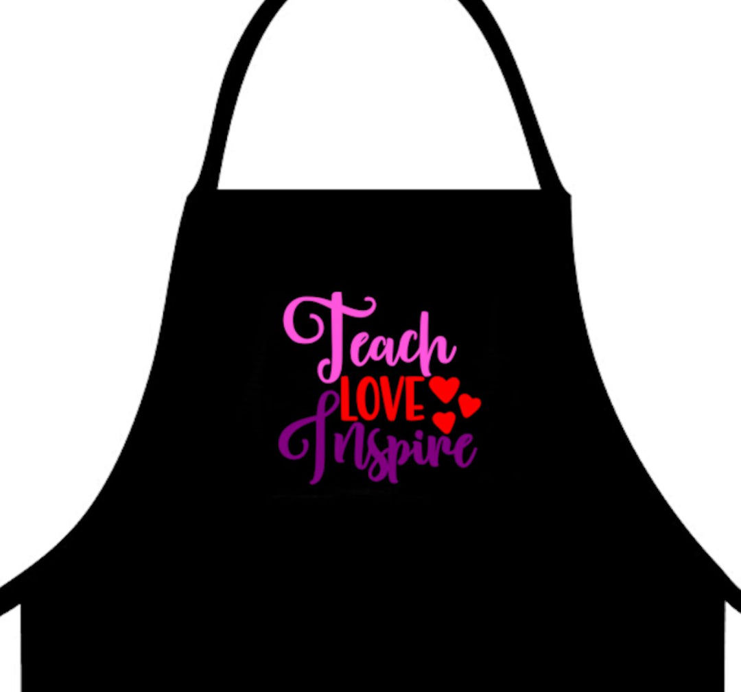 Teach Love Inspire Apron - A durable and stylish apron perfect for educators, providing a functional and inspiring look for teachers in classrooms or workshops.