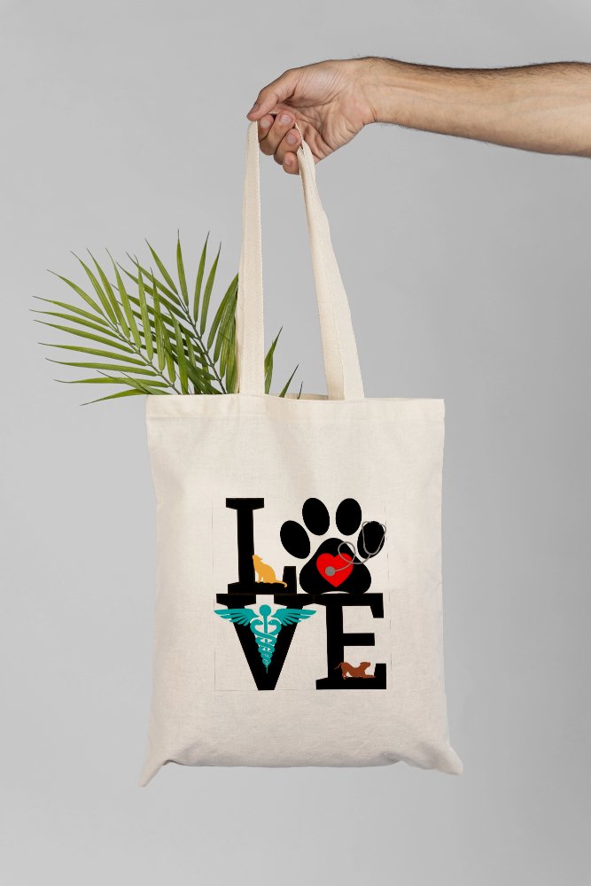 cotton canvas tote bag with printed image of the word LOVE in a square. There are coloured images of cats, dogs and paws within the word love. Gifts for vets and veterinary nurses