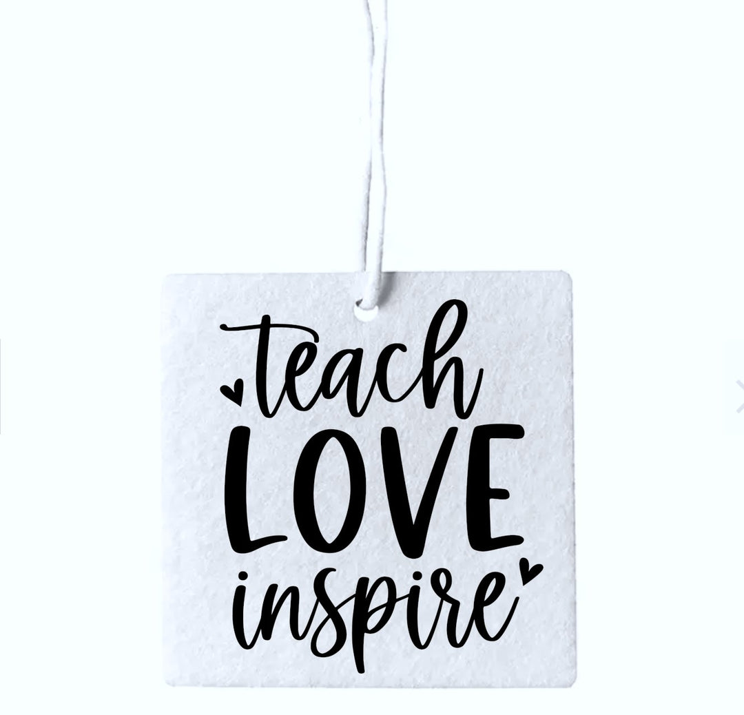 Set of three 'Teach Love Inspire' air fresheners, featuring motivational quotes and appealing designs, perfect for enhancing the atmosphere in classrooms, offices, or home spaces.