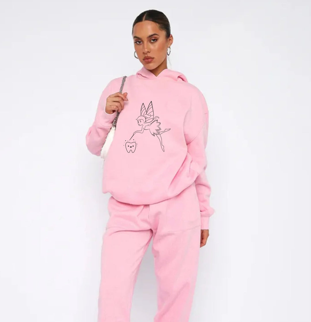 Soft pink hoodie featuring a playful Tooth Fairy design, perfect for casual wear and celebrating childhood magic.